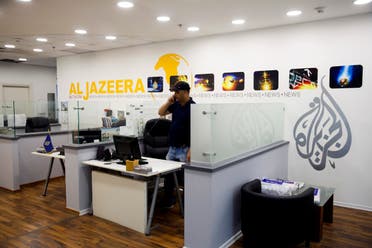 An employee talks on the phone in Al-Jazeera news network offices in Jerusalem. (File photo: AP)