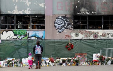 In this Dec. 13, 2016, file photo, flowers, pictures, signs and candles, are placed at the scene of a warehouse fire in Oakland, Calif. (AP)