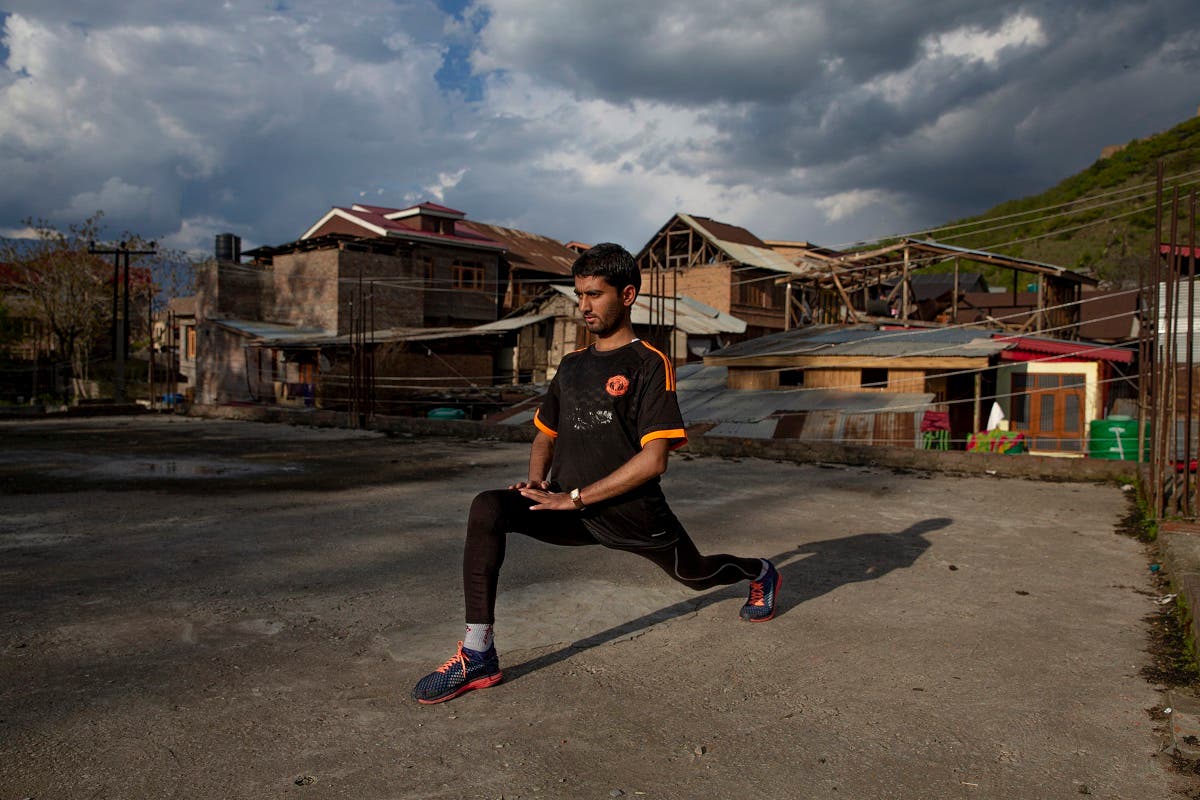 An ultra-marathon runner Hamid Aziz practises on the roof of an abandoned community hall outside his house in Srinagar Indian controlled Kashmir, on April 21, 2020. (AP)