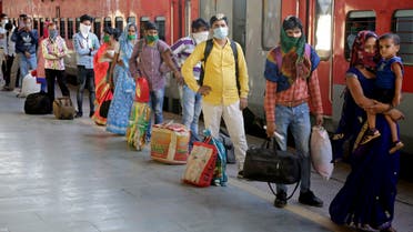 Migrant workers wait to board a special train to return to Agra in Uttar Pradesh state, at a railway station in Ahmedabad, Gujarat, on May 2, 2020. (AP)