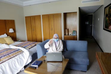 Nurse anesthetist Teimi Hakima uses a laptop to make a video call and speak with her family in her room at hotel Dawliz in Sale. (Reuters) 