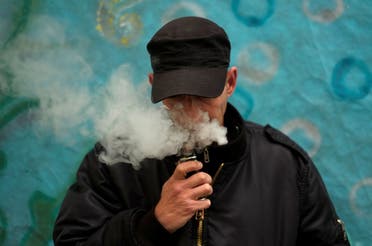 A man poses for a picture, as he vapes at home in La Paz. (Reuters)