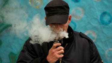 A man poses for a picture, as he vapes at home in La Paz. (Reuters)