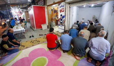 Iraqi muslims perform Ramadan prayers at a store, after the Iraqi government ordered all mosques to stay closed, during the holy fasting month of Ramadan, in Baghdad's Adhamiya district. (Reuters)
