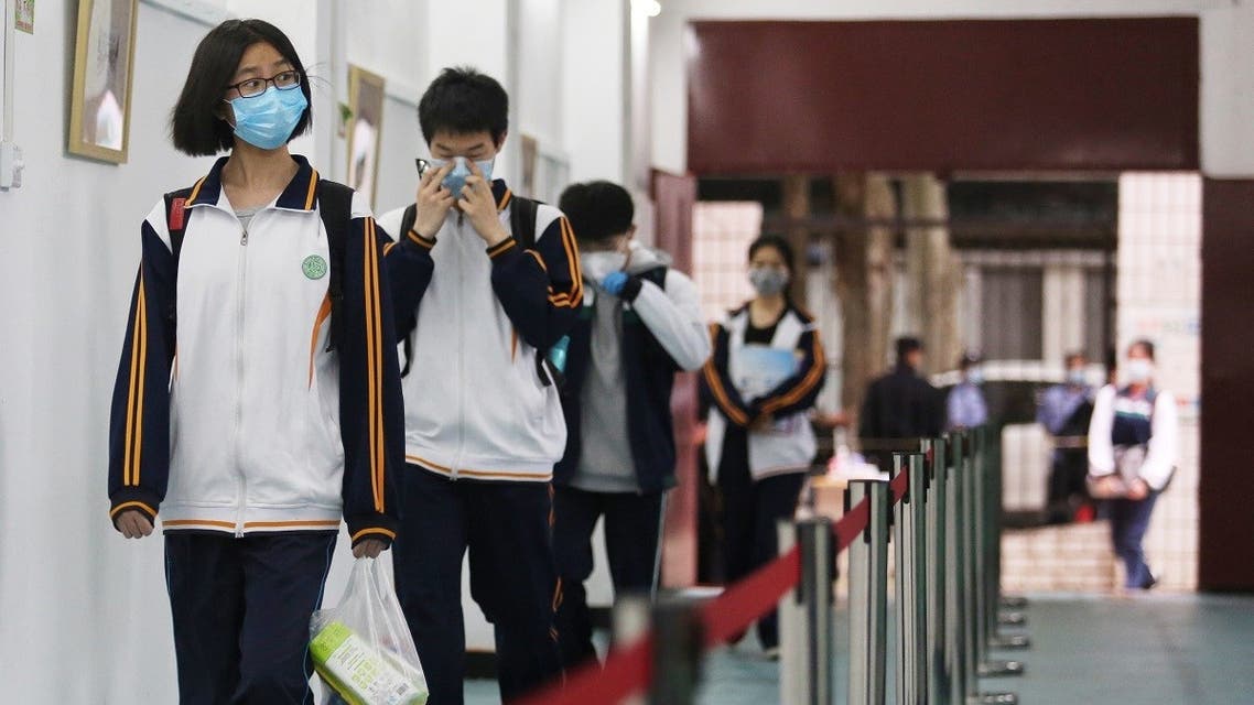 Senior students enter a high school in Wuhan in China's central Hubei province on May 6, 2020. (AFP)