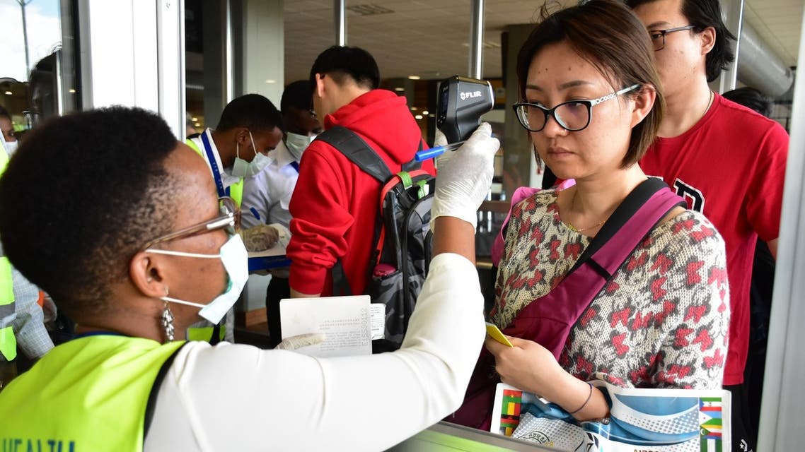 A tourist from China are screened by Tanzanian health services staff upon arrival at the Kilimanjaro International Airport Northern Tanzania on January 29, 2020. (AFP)