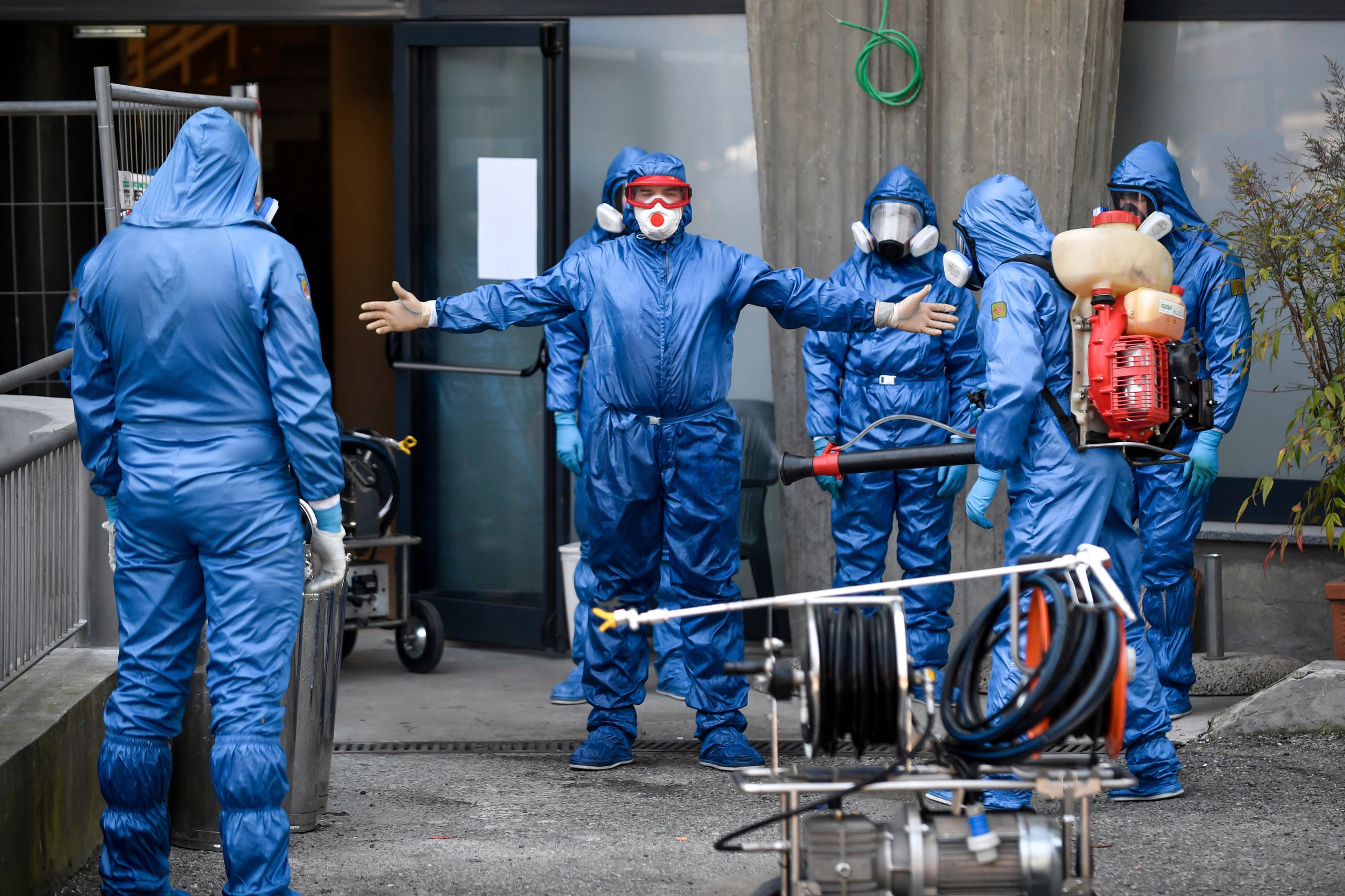 Members of a Russian team sanitize a hospice for elderly people to contain the spread of the Covid-19 virus, in Albino, near Bergamo, northern Italy on March 28, 2020. (AP)