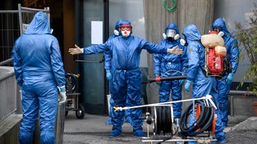 Members of a Russian team sanitize a hospice for elderly people to contain the spread of the Covid-19 virus, in Albino, near Bergamo, northern Italy on March 28, 2020. (AP)