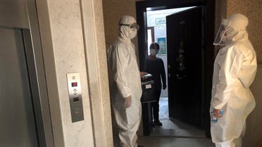 Medics wearing protective suits, members of Turkish Health Ministry's coronavirus contact tracing team, visit a home to check a suspected coronavirus disease (COVID-19) case in Ankara, Turkey, April 27, 2020. Picture taken April 27, 2020. REUTERS/Tuvan Gumrukcu
