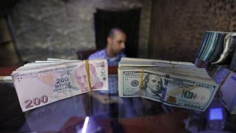 Turkey bans 3 banks from transactions as lira hits record low against the dollar