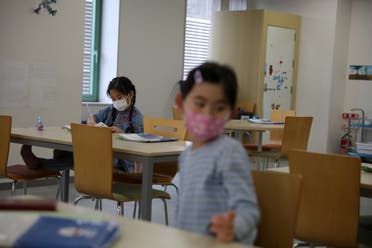 Children, wearing protective face masks, following an outbreak of coronavirus, are seen at a daycare center in Tokyo, Japan, March 5, 2020. (Reuters)