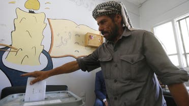 A man casts his ballot for Syria's first local elections since 2011, on September 16, 2018 in the southern Eastern Ghouta, on the eastern outskirts of the capital Damascus. Polling booths opened at 7:00 am (0400 GMT) across government-held parts of the country and will be open for 12 hours, with a potential five-hour extension depending on turnout, reported state news agency SANA.
