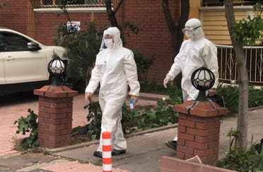 Medics wearing protective suits, members of Turkish Health Ministry's coronavirus contact tracing team, visit a home to check a suspected coronavirus disease (COVID-19) case in Ankara, Turkey, April 27, 2020. (Reuters)