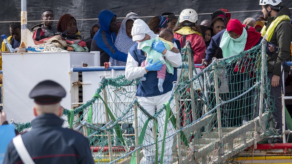 Migrants rescued in the Mediterranean sea disembark from the Sea Watch NGO's ship on February 27, 2020 in the port of Messina, Sicily. (AFP)