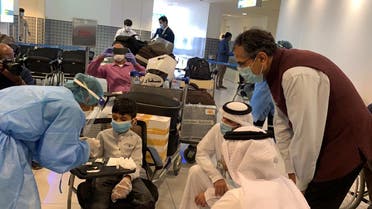 Indian Ambassador to UAE Pavan Kapoor is seen with some of the passengers undergoing medical screening at Abu Dhabi airport before they board the Abu Dhabi-Kochi repatriation flight, on Thursday. (Twitter)