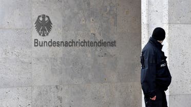 A policeman stands guard next to the logo and name of the German Federal Intelligence Service (BND) on February 8, 2019 outside its headquarters in Berlin. Located where the Berlin Wall once dissected the city, the 1.1 billion euro ($1.25 billion) complex now houses 4,000 of the spy agency's 6,500 staff.