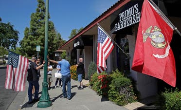 People wait in line to have their hair cut at a barbershop on May 4, 2020, in Vacaville, California. (AP)