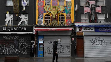 A man wearing a mask walks past closed shops in Camden, following the outbreak of the coronavirus disease (COVID-19), in London, Britain, April 30, 2020. (Reuters)