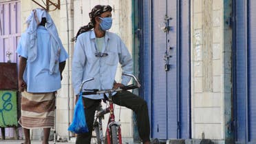 A man wearing a protecitve face mask rides a bicycle during a curfew amid concerns about the spread of the coronavirus disease (COVID-19) in Aden, Yemen April 30, 2020. REUTERS/Wael al-Qubati