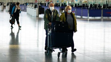 People wearing masks are seen at Heathrow airport, as the spread of the coronavirus disease (COVID-19) continues, London, Britain, April 5, 2020. (Reuters)