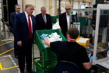 President Donald Trump participates in a tour of a Honeywell International plant that manufactures personal protective equipment, Tuesday, May 5, 2020, in Phoenix, with Tony Stallings, vice president of Integrated Supply Chain at Honeywell, right and White House chief of staff Mark Meadows. (AP)
