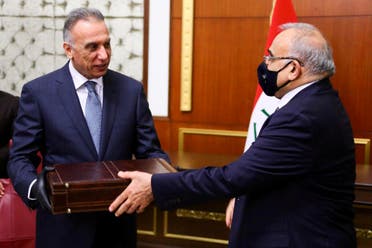 Former Iraqi Prime Minister Adel Abdul Mahdi hands over to new Prime Minister Mustafa al-Kadhimi in Baghdad. (Reuters)