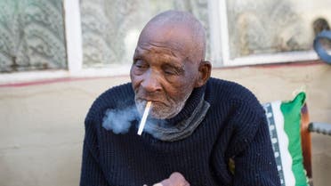 Fredie Blom enjoys a cigarette as he celebrates his 116th birthday at his home in Delft, near Cape Town. (Reuters)