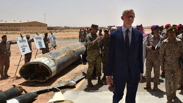 Brian Hook (R), the US special representative on Iran, checks what Saudi officials said were Iranian-made Huthi missiles and drones intercepted over Saudi territory and the remnants of a cruise missile that slammed into Abha airport on June 12, during a visit to an army base in al-Kharj, south of the Saudi capital Riyadh, on June 21, 2019. (AFP)