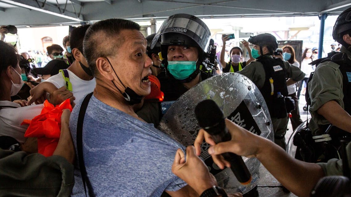 Police officers clash with a pro-democracy demonstrator (C) in the Tsim Sha Tsui waterfront during a pro-democracy protest calling for the city's independence in Hong Kong on May 10, 2020. (AFP)