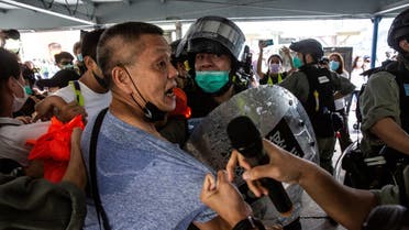 Police officers clash with a pro-democracy demonstrator (C) in the Tsim Sha Tsui waterfront during a pro-democracy protest calling for the city's independence in Hong Kong on May 10, 2020. (AFP)