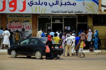 Residents of the Sudanese capital Khartoum queue in front of a bakery, on April 9, 2020. (AFP)