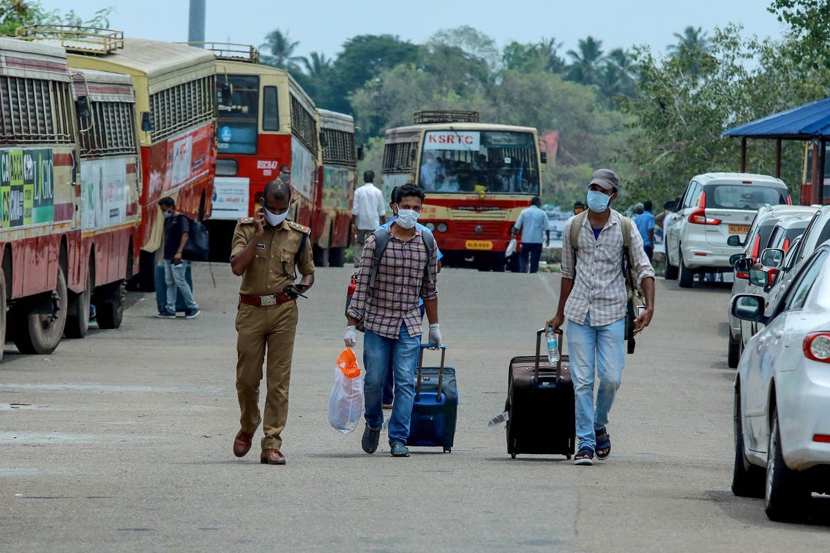 Indian citizens evacuated from Maldives with a special ship INS Jalashwa are being shifted to a quarantine center by bus, as part of a massive repatriation effort in Kochi in the south Indian state of Kerala on May 10, 2020. (AFP)