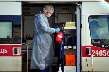 A medical worker sprays disinfectant at his ambulance in St. Petersburg, Russia on May 4, 2020. (AP)