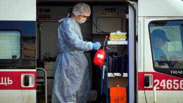 A medical worker sprays disinfectant at his ambulance in St. Petersburg, Russia on May 4, 2020. (AP)