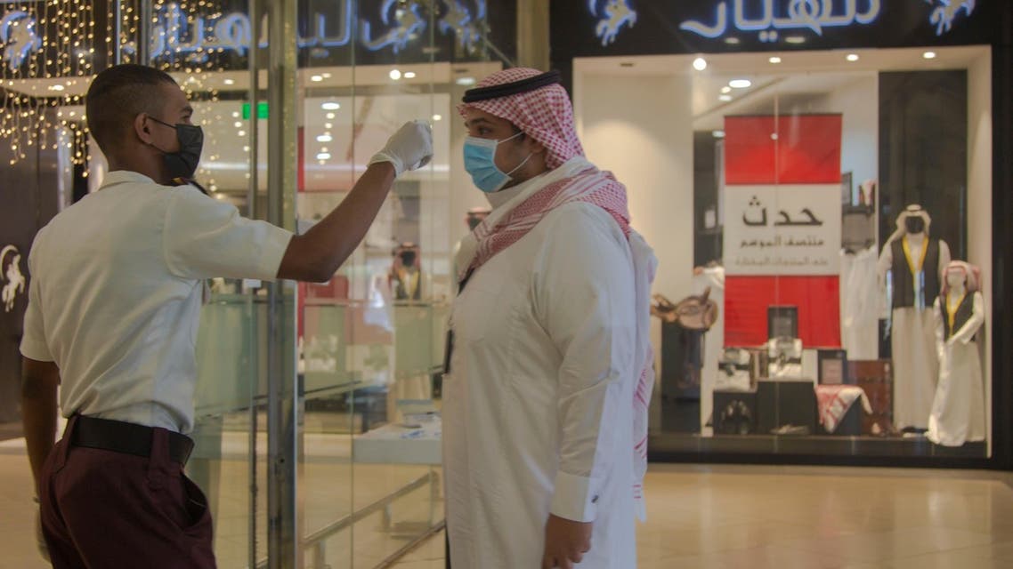 Mall security checks temperature of people visiting a local mall in Medina, Saudi Arabia. (SPA)