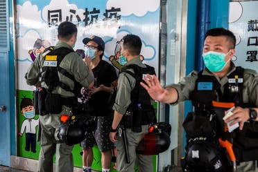 Police officers talk to a man as they patrol in Hong Kong on May 10, 2020. (AFP)