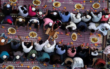 Muslims distribute food as they wait to have their Iftar (breaking fast) meals outside a mosque during the holy fasting month of Ramadan, in Manama, Bahrain, May 10, 2019. (File photo: Reuters)