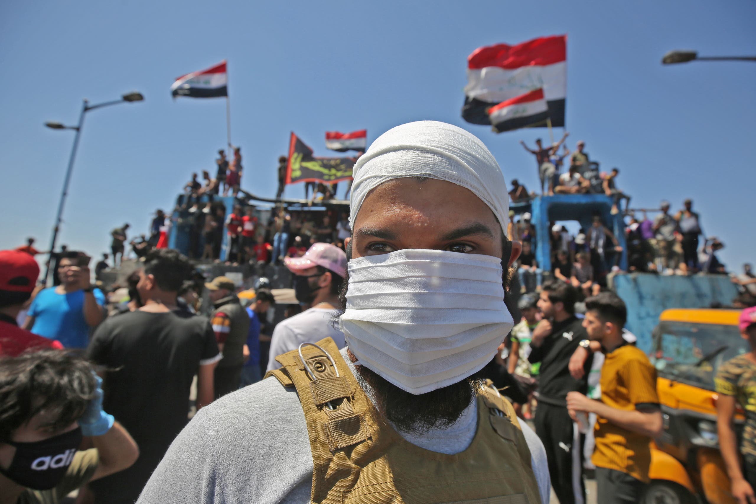 An Iraqi protester wears a face mask during an anti-government demonstration on Al-Jumhuriyah bridge in the capital Baghdad, on May 10, 2020. (File photo: AP)