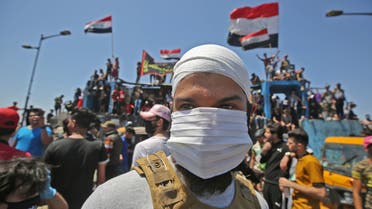 An Iraqi protester wears a face mask during an anti-government demonstration on Al-Jumhuriyah bridge in the capital Baghdad, on May 10, 2020. (File photo: AP)