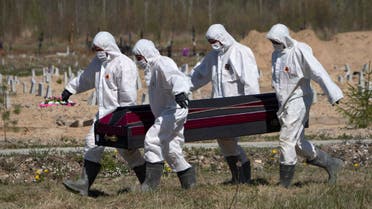 Grave diggers carry a coffin while burying a COVID-19 victim in a cemetery in Kolpino, Russia on May 10, 2020. (AP)
