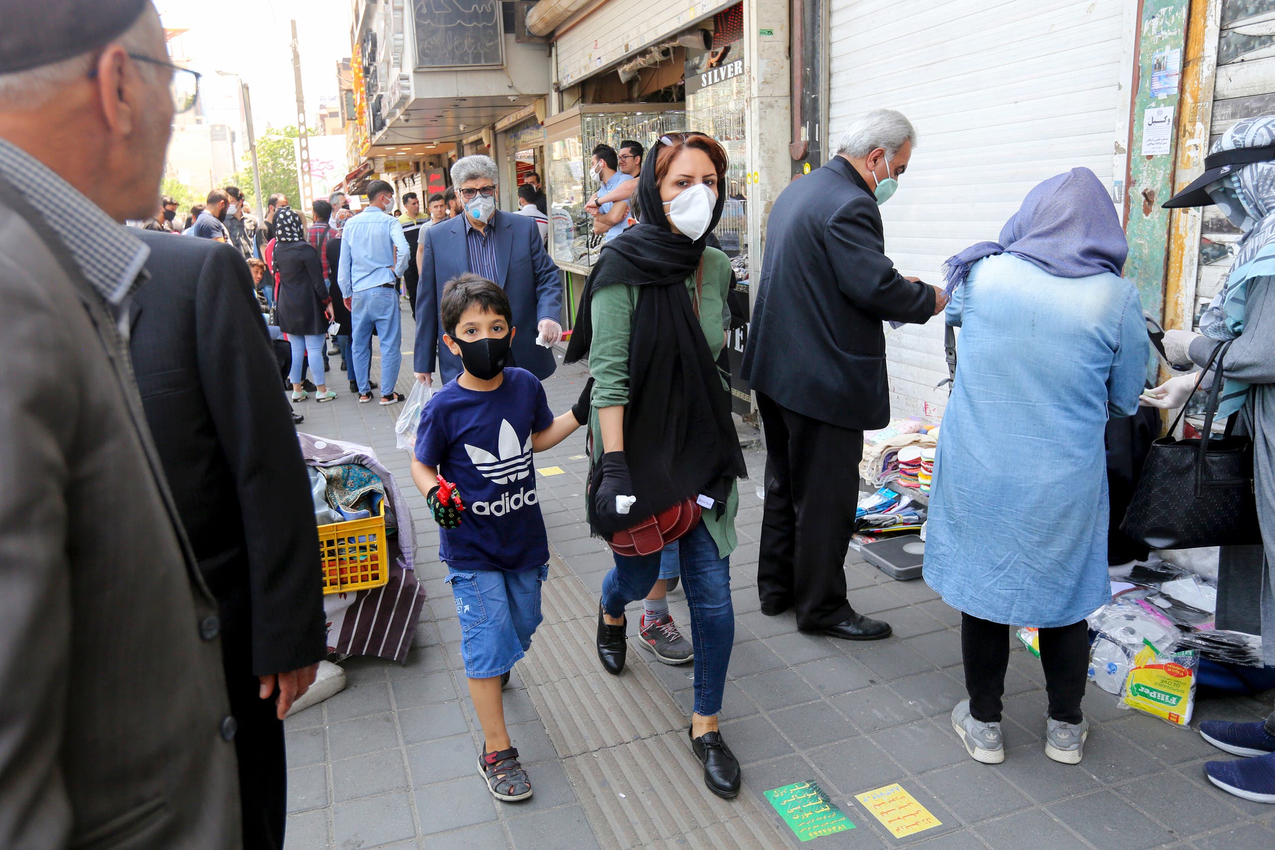 People walking with face masks on the streets of Tehran on May 9, 2020. (AFP)