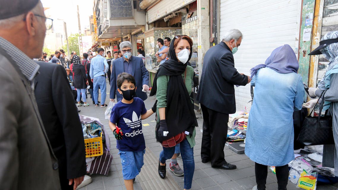 Iranian people walking with face masks in Tehran, May 9, 2020. (File photo, AFP)