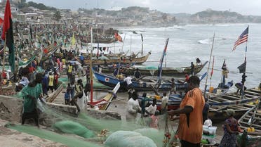 Fishermen tend their boats and fishing nets as members of a heritage tour group, traveling to Ghana to discover their roots, visit the Cape Coast castle, Ghana August 12, 2019. Picture taken August 12, 2019. (Reuters)