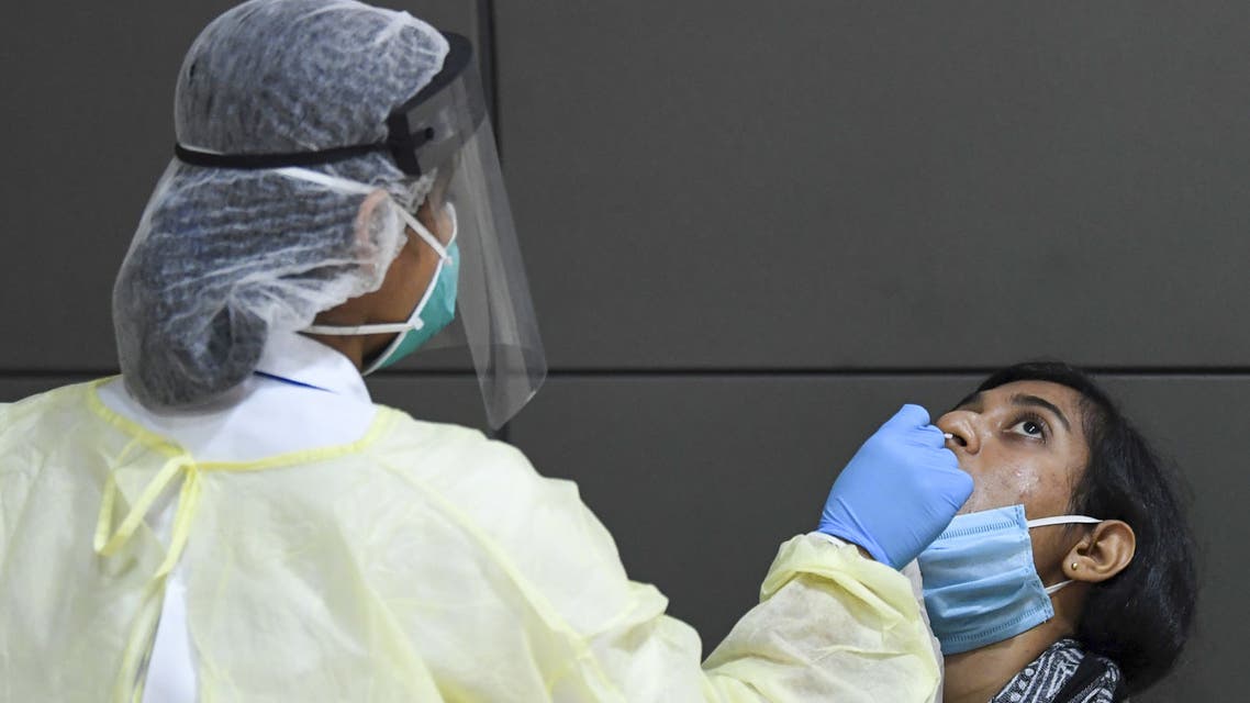 A member of an Indian medical team is tested upon the team's arrival at Dubai International Airport on May 9, 2020, to help with the coronavirus (COVID-19) pandemic.