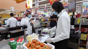 People wearing protective face masks and gloves shop at a supermarket, following the outbreak of the coronavirus disease (COVID-19), in Riyadh, Saudi Arabia. (Reuters)