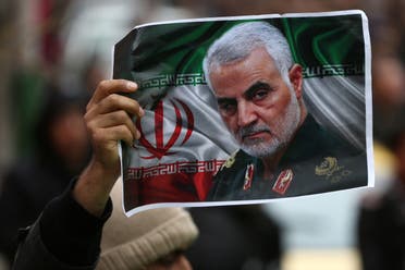 An Iranian holds a picture of slain General Qassem Soleimani as people gather to mourn him in Tehran, Iran on January 4, 2020. (Reuters)