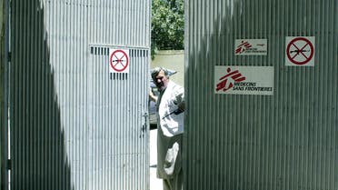 An Afghan security guard looks through the gate of the NGO Medecins Sans Frontieres (Doctors Without Borders) in Kabul. 03 June 2004. (AFP)