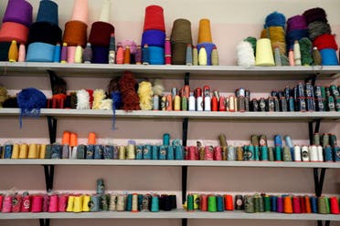 Reels of thread are seen at Bokja's atelier, which specializes in making upholstered furniture and now is dedicating their time to sewing colorful silk face masks, in Beirut. (Reuters)