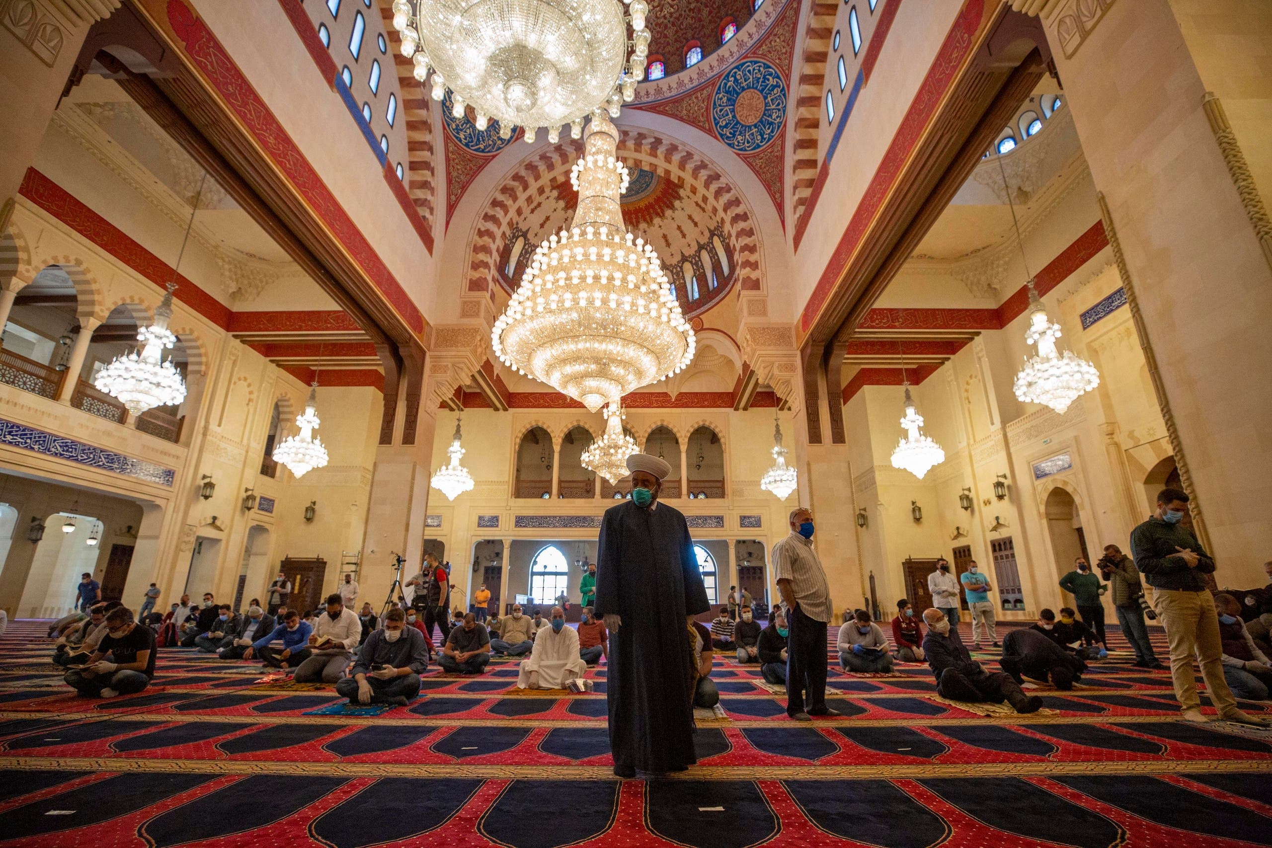 Muslim worshippers wearing masks offer Friday prayers while maintaining a social distance at the Mohammad al-Amin Mosque in Beirut on May 8, 2020. (AP)