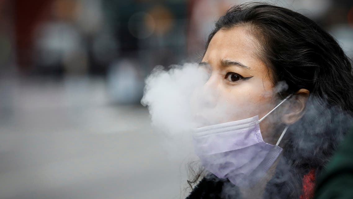 A woman exhales after vaping in Times Square, during the coronavirus outbreak, in New York City, US, March 31, 2020. (Reuters)